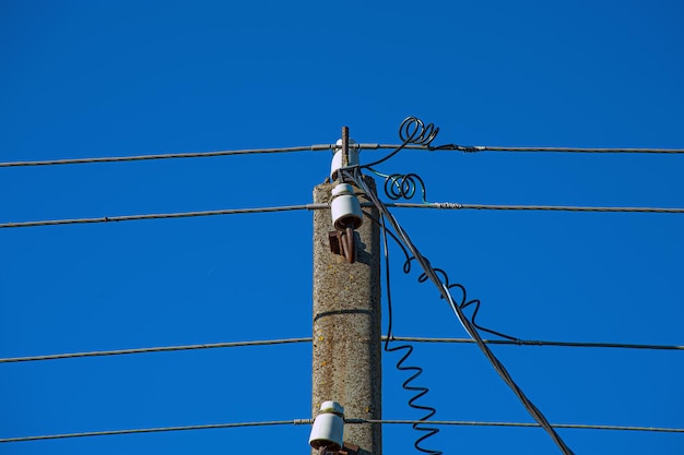 Electric lines overhaead power line against bles sky