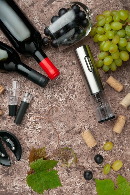 Electric metal corkscrew wine aerator and vacuum stopper On a brown concrete background