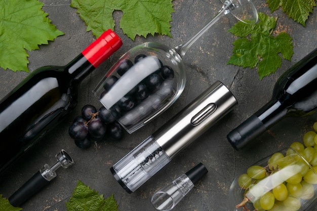 Electric metal corkscrew wine aerator and vacuum stopper On a gray concrete background