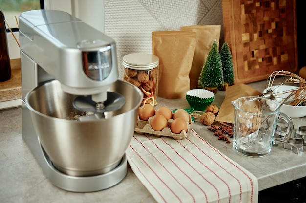 Electric mixer kneads dough in the kitchen