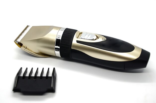 Electric pet clipper with plastic nozzle on white. Grooming tools for hygienic care of pets