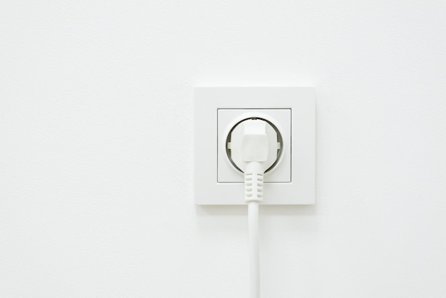 Electric plug of some electronic device in outlet