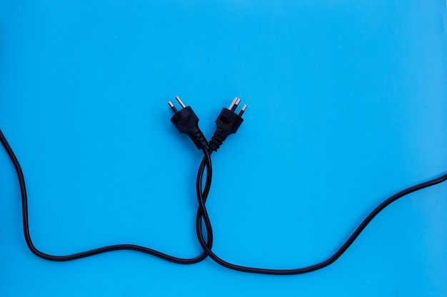 Photo electric plugs on blue wall. top view