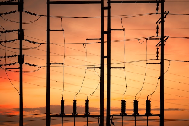 Electric pole silhouette with orange sky at sunset