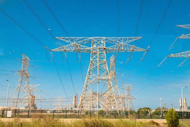 an electric pole with high voltage lines and cables for transmitting energy to consumers electrification and industry