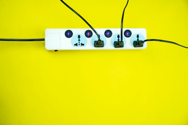 Electric power socket and plug on yellow paper background