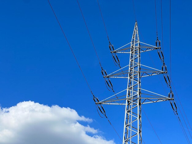 Electric pylon against blue sky