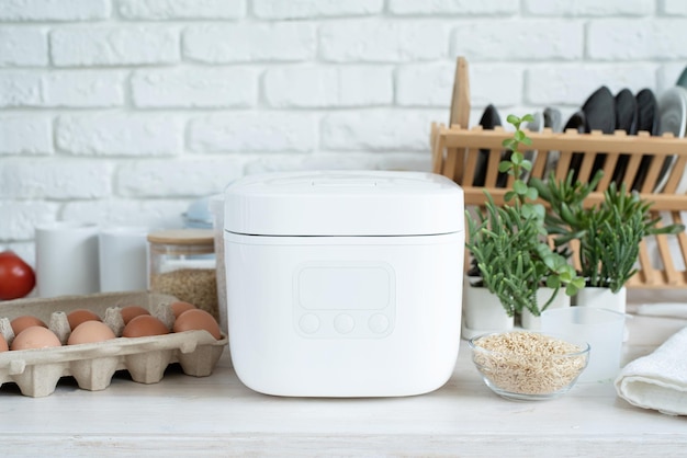 Electric rice cooker on wooden countertop in the kitchen