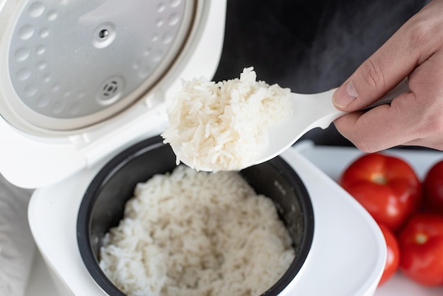 electric rice cooker on wooden countertop in the kitchen