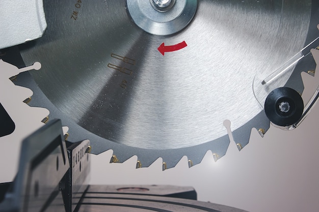 Photo electric saw, iron circular saw blade for wood saw. a close-up of a circular saw