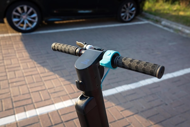 An electric scooter is parked in a parking lot in the city Ecological transport Urban lifestyle