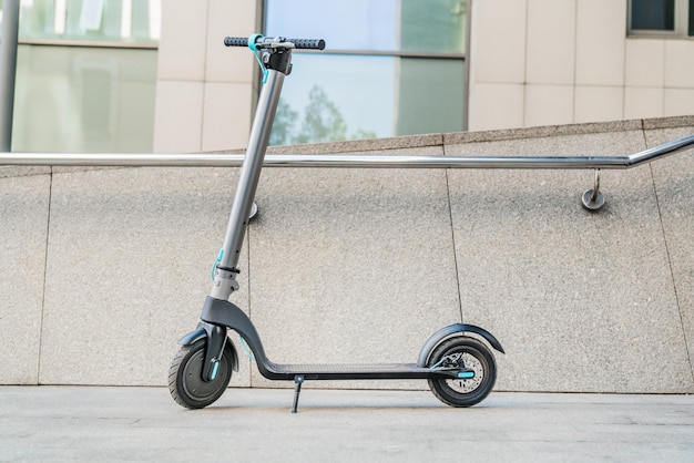 Electric scooter near business center street wall