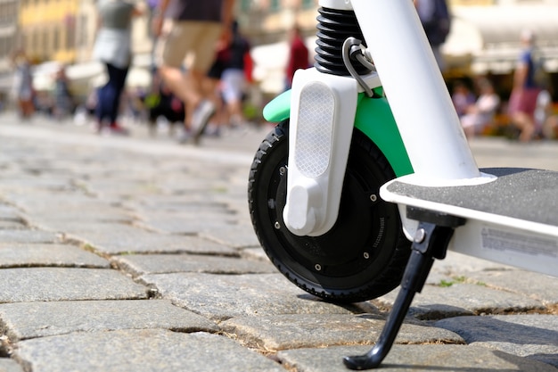 Electric scooter parked on pavement at old city center