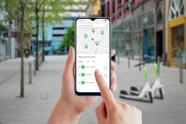 Electric scooter sharing platform app on smartphone City street and scooters in background