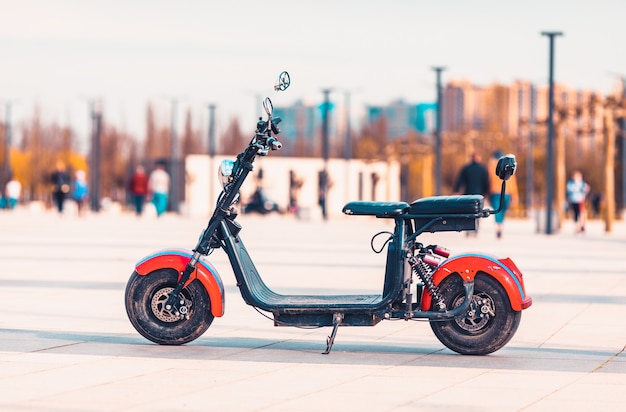 Electric scooter on urban background