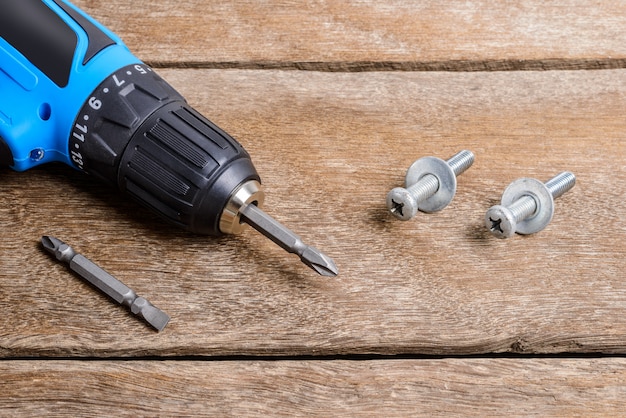 Electric screwdriver on wooden table