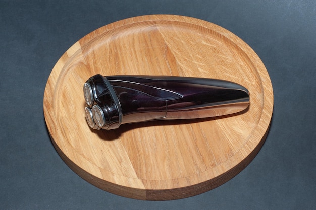 Electric shaver for man on table wood.