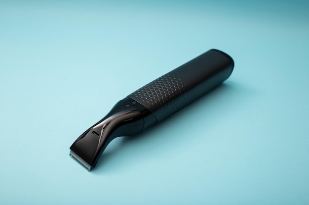 Electric shaver with attachments on a blue background