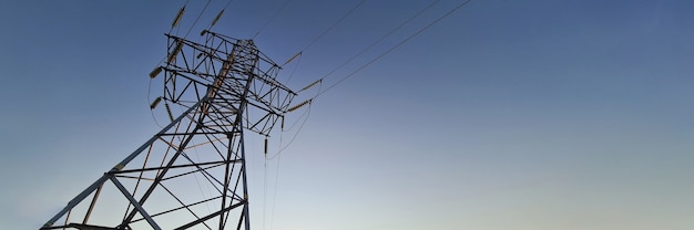 Electric station with wires standing on background of sunset closeup