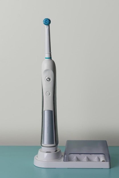 Electric toothbrush set. modern rechargeable sonic or electric\
toothbrush set with charger. concept