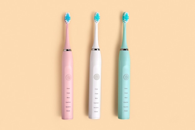 Electric Toothbrush Top View Flat Lay Copy Space Dental Care Supplies on Beige Pastel Studio Background Oral Hygiene Gum Health Healthy Teeth Modern Dental Ultrasonic Vibration Tooth Brush Set