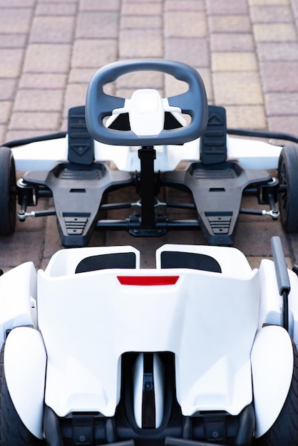 Electric toy car with a futuristic design view from above\
attraction for entertaining children outdoors in the park electric\
scooter
