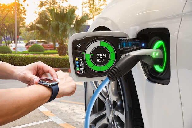 Electric vehicle changing on street parking with graphical user\
interface synchronize with smart watch future ev car concept