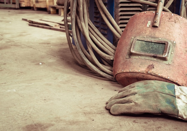 Electric welding machine, electric wire, masks, gloves and tongs, are very old