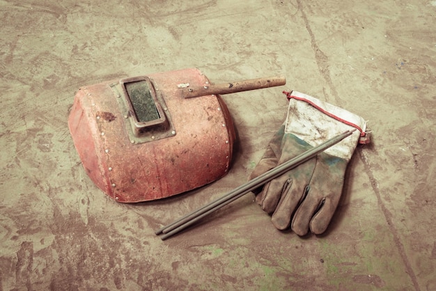 Electric welding machine, electric wire, masks, gloves and tongs, are very old