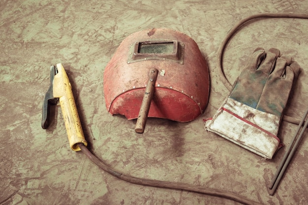 Electric welding machine, electric wire, masks, gloves and tongs, are very old