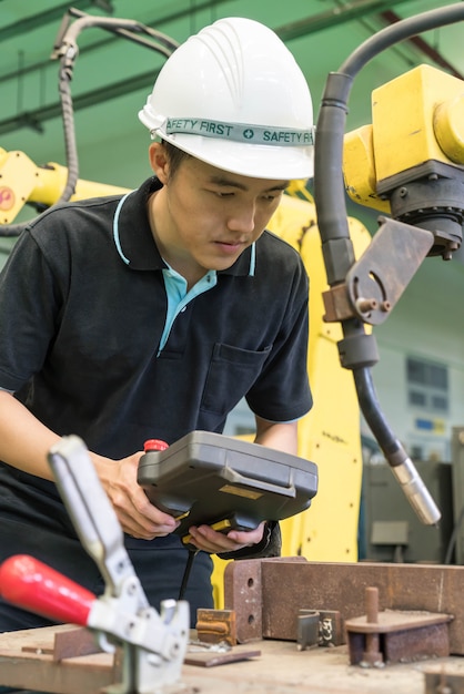 Electrical engineer working with a robot machine