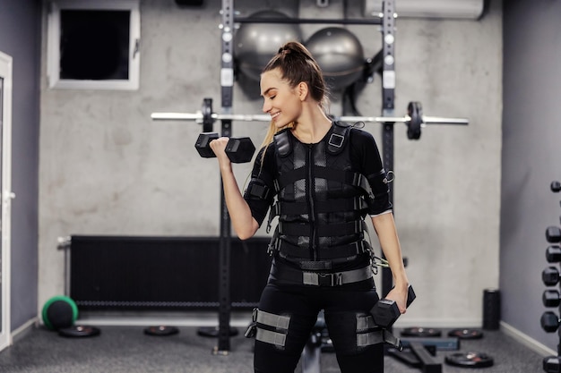 Electrical muscle stimulation EMS training studio A sporty girl wearing an EMS suit