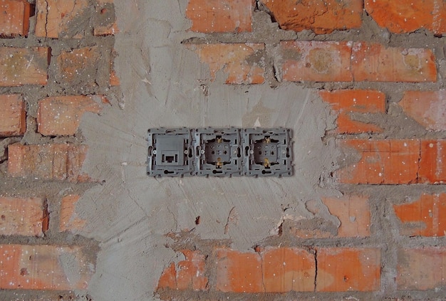 Electrical Outlet Plug Mounted In A Brick Wall