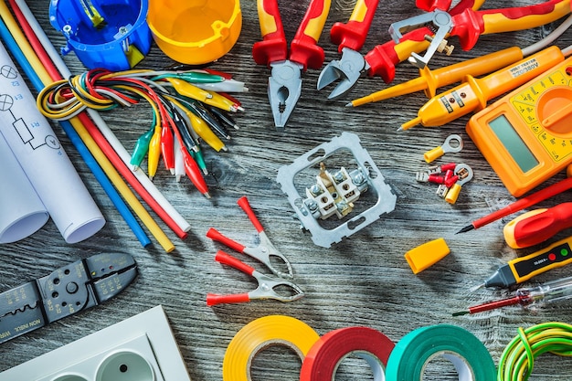 Electrical tools set on vintage wood background