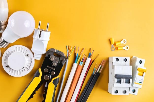 Electrical tools set with dimmer switch isolated on yellow\
background with copy space controllable lighting saving energy\
concept building and renovation