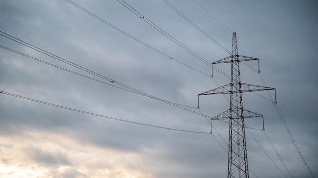 Electrical tower under a cloudy sky