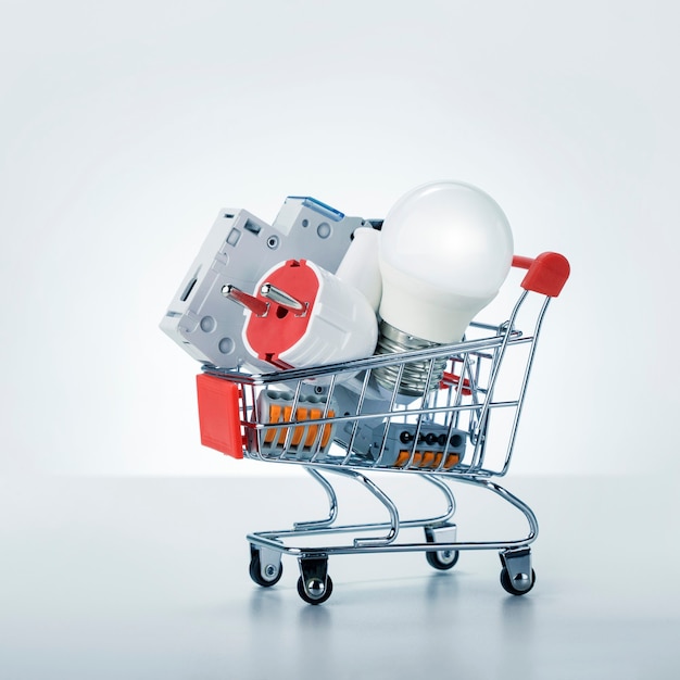 Electrician equipment in a shopping cart on white background