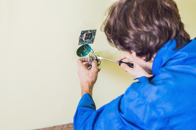 Electrician Installing Socket In New House