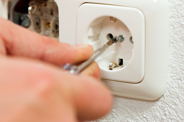 Electrician installing socket