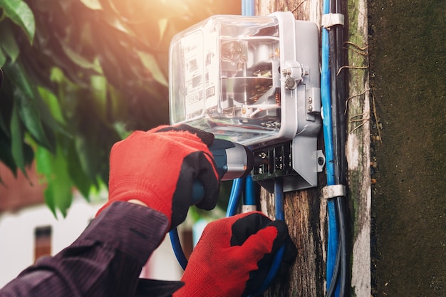 Electrician installing watthour meter at home