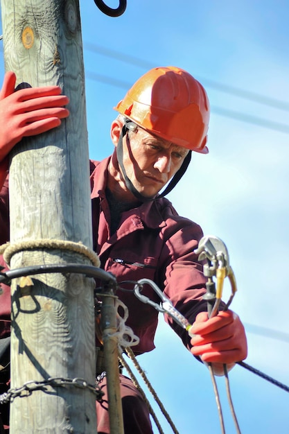 Electrician installs the grounding on the power line before repairing it