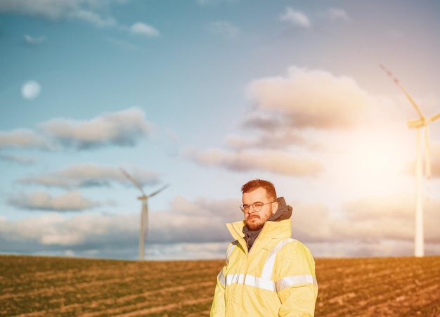 Electrician near wind turbines Concept of renewable green energy