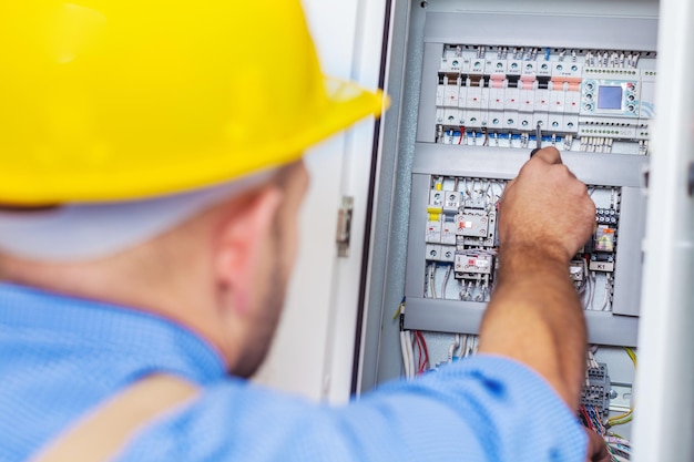 Electrician repairing test technician electric inspecting power