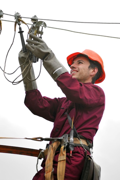 Electrician repairman installs the grounding on the power line before repairing it.