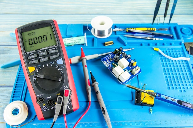 The electrician's workplace. Electronics. Schemes soldering iron. multimeter