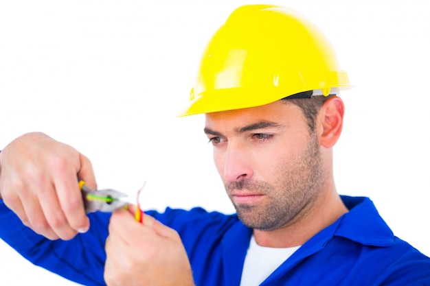 Electrician wearing hard hat while cutting wire