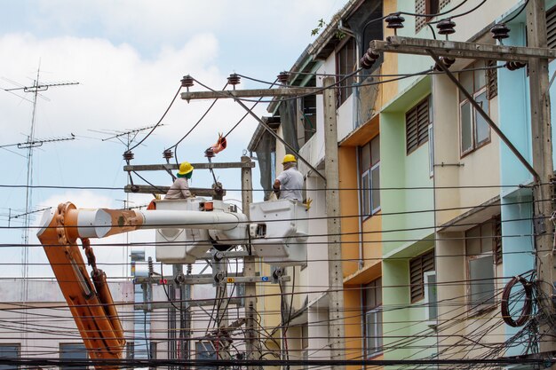 The electrician went up to the crane basket