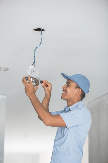 Electrician wiring a ceiling light