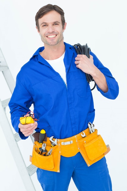 Electrician with wire roll and multimeter