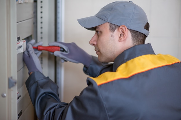 Electrician at work on electric panel